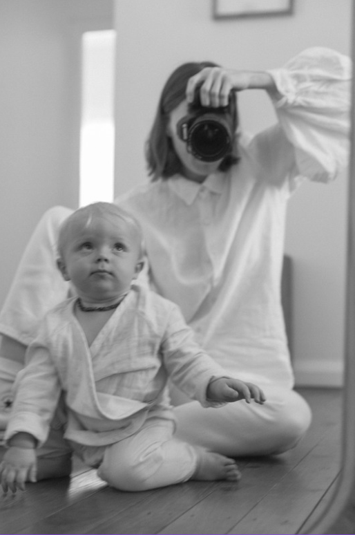 black and white photo of tilly & ophelia, seated with camera