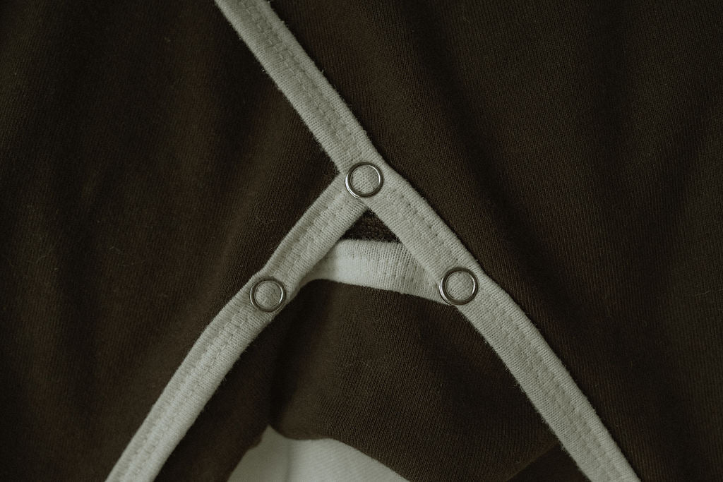 Metal snaps on a brown fabric background